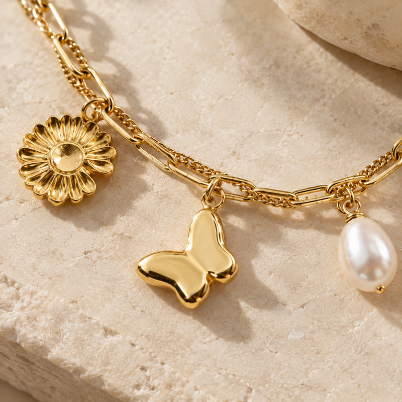Daisy & Butterfly Charm Bracelet — Multi-strand charm bracelet with daisy and butterfly charms (styled on model)