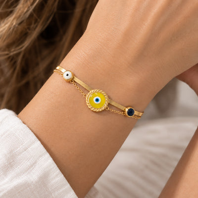 Evil Eye Serpent Cuff — Serpent-link cuff with three enamel evil-eye charms (close-up detail)