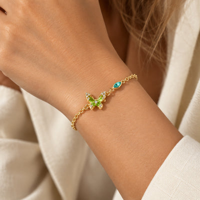 Emerald butterfly bracelet worn on wrist, side view