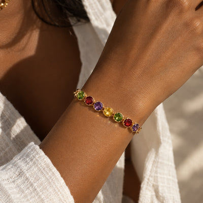 Gem Row Paperclip Bracelet — Rose gold-tone paperclip chain with a row of colored stones (close-up detail)