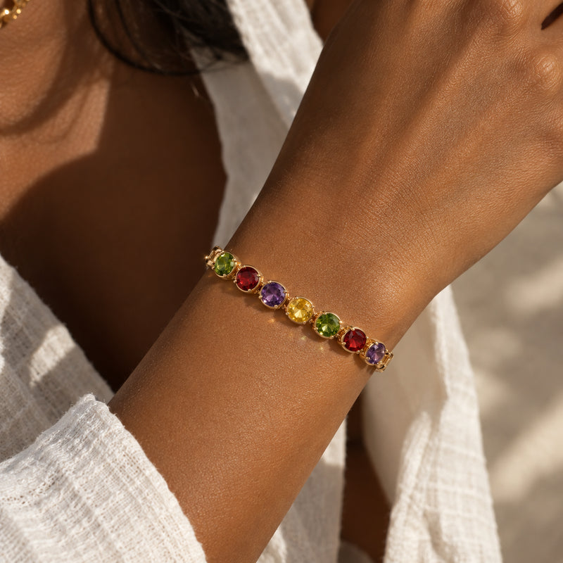 Gem Row Paperclip Bracelet — Rose gold-tone paperclip chain with a row of colored stones (close-up detail)
